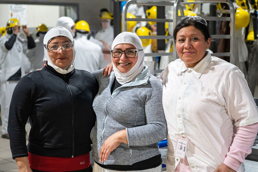 Three workers at Canada Packers posing for a photo
